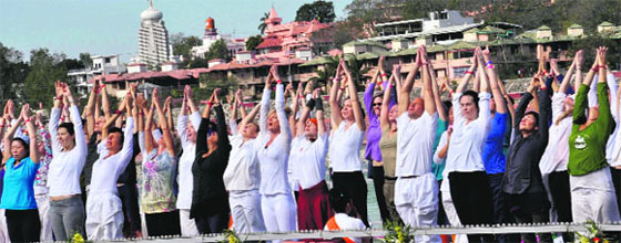 Foreigners do yoga along the Ganga ghat at Rishikesh before the natural disaster that struick Uttarakhand last month casting a shadow on tourist inflow to Rishikesh. 