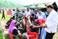 Doctors of Art of Living treating victims of the natural disaster at Gauchar.