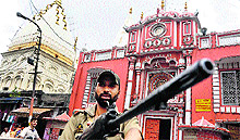 A policeman stands guard outside the Raghunath temple in Jammu on Sunday
