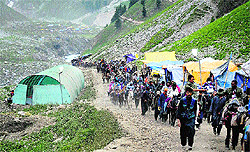 Pilgrims on their way to the Amarnath cave shrine cross the Baltal area in Sonamarg on Sunday