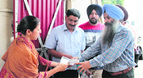 Members of a team from the Health Department distribute chlorine tablets among the residents of Maqsudan in Jalandhar.