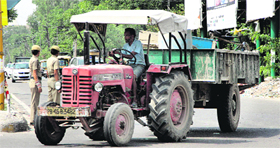 Despite ban, a tractor-trailer being used in front of women traffic police officials for commercial purposes at Guru Nank Mission Chowk, Jalandhar.