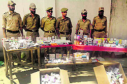 Police officials with drugs siezed from four chemist shops at Pattan in Baramulla district