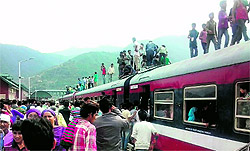 Passengers travel on the roof of a train