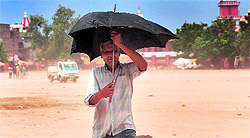 A man protects himself from the scorching sun in Ludhiana