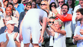 Andy hugs his mother Judy Murray after climbing into the players box to celebrate the win.