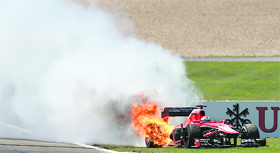 The car of Frenchman Jules Bianchi of Marussia catches fire during the race.