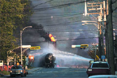 Firefighters douse a blaze after a freight train loaded with oil derailed in Lac Megantic in Canada's Quebec province on Saturday sparking explosions that engulfed about 30 buildings in fire.