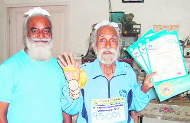 Joginder Singh, escorted by his son in law Gulshinder, displays the medals won by him in veterans meet.