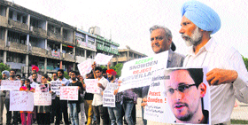 City residents stage a protest in support of US whistleblower Edward Snowden at Sector 17, Chandigarh, on Monday.