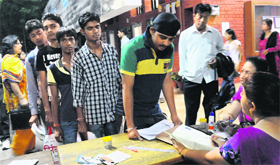 Candidates seeking admision to Class XI submit their forms during the first counselling.