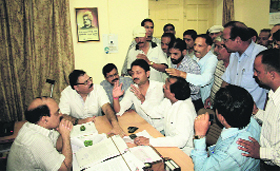 Congress city councillors, led by local legislator Raj Kumar, argue with Mukhya Nagar Adhikari Ashok Kumar of the Dehradun Municipal Corporation on Monday.