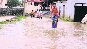 Water accumulates in the Morowala area of Clement Town following heavy rain in Dehradun on Monday.