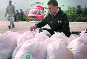Oxfam volunteers send relief material through helicopters at Guptkashi on Monday.