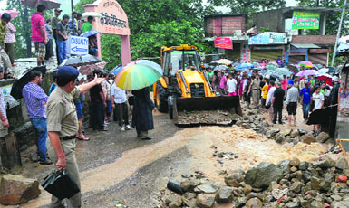The damaged road outside the Zonal Hospital in Mandi on Sunday. 