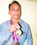Chand Singh Yadav shows his medal.