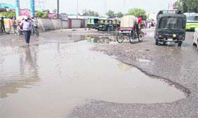 Potholes on the approach road of the bus stand