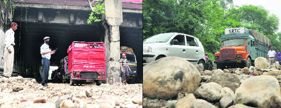 Traffic police near the Railway underbridge in Railhead area of Jammu as waterlogging set off traffic snarls; (right) vehicles line up in the area as heavy rain wreaked havoc on the citys roads on Monday.