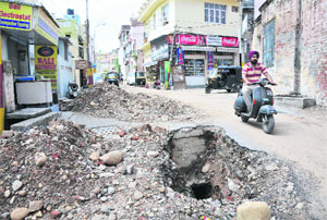 Commuters face problems due to digging of a road near Mubarak Mandi Heritage Complex in Jammu on Monday.