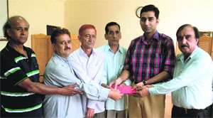 A delegation of the Beopar Mandal, Reasi, hands over the relief fund to the Deputy Commissioner on Monday.