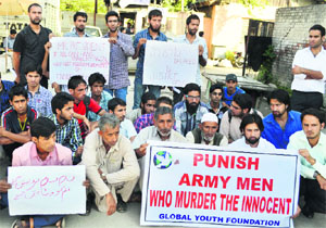 Family members of the victims stage a protest in Srinagar on Monday. 