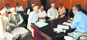 Chief Minister Omar Abdullah talks to a delegation in Srinagar on Monday.