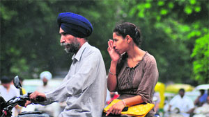 A father-daughter duo heads home on a rainy Monday in Ludhiana.