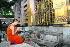 A monk offers prayers at Mahabodhi Temple in Bodh Gaya on Monday.