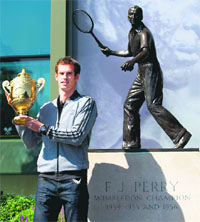 Andy Murray stands next to a statue of Fred Perry, the last British player to win the same event in 1936, at the All England Club in Wimbledon, on Monday. 