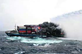 In this Defence Ministry photograph received on Monday, merchant vessel Mol Comfort burns as the Indian Coast Guard ship Samudra Prahari sends down a column of water to extinguish the flames