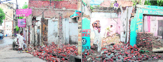 Shopkeepers demolish their establishments in the Ghee Mandi area in Amritsar on Tuesday. 
