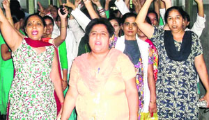 Members of the Nursing Association protest at the Guru Nanak Dev Hospital in Amritsar on Tuesday. 