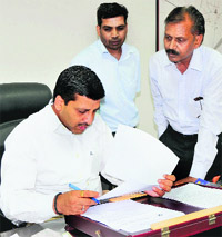 Municipal commissioner Uma Shankar Gupta attends to a complaint at the grievance redressal camp of the Municipal Corporation, Bathinda, on Tuesday. 