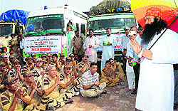 Dera Sacha Sauda chief Gurmeet Ram Rahim Singh with relief vehicles bound for Uttrakhand in his dera at Sirsa on Tuesday