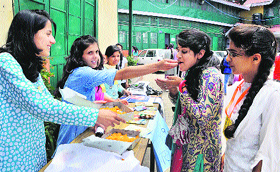 Activists of the ABVP distribute sweets on the foundation day of RKMV in Shimla on Tuesday.
