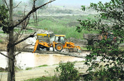 Illegal mining takes place by employing a JCB machine in a river in the Nurpur area of Kangra district. A Tribune photograph