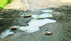 A potholed road seen in the Aima locality of the town.