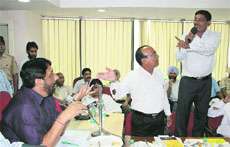 Congress councillors Jagdish Raja and Des Raj Jassal argue with Mayor Sunil Jyoti during the Municipal Corporation House meeting in Jalandhar on Tuesday. 