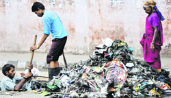 The amount of polythene bags choking the drains has surprised JMC authorities busy cleaning them in the monsoons. Tribune photo: Inderjeet Singh