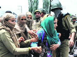 Policewomen arrest members of the National Youth Corps at the exhibition crossing during a protest in Srinagar on Tuesday. Tribune Photo: Amin War