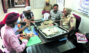 The Government Railway Police with the cash seized from two passengers at the Ludhiana railway station. 