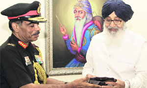 Lt Gen Philip Campose presents a memento to Chief Minister Parkash Singh Badal in Chandigarh on Tuesday. 