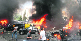 Civilians gather at the explosion site in Beirut on Tuesday.