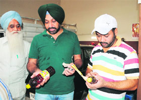 A Health Department team collects samples during a raid at an oil manufacturing factory in Amritsar on Wednesday