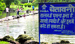 Ignoring the warning, boys take a dip in a pond at HUDA Park, Sector 5, Panchkula