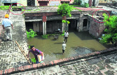 The roof of the DEO office has caved in at several places and employees wade through water to reach their rooms in Jalandhar. 
