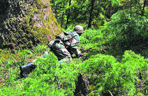 An Army soldier takes position during an operation in Kupwara district on Wednesday. 