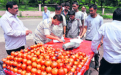 A JMC team fines a vendor for using polythene bags in Jammu on Wednesday