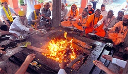 Residents perform havan for Uttarakhand disaster victims at Sri Lakshmi Naryana Temple in Jammu on Wednesday