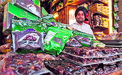 A shopkeeper sells dates at his business establishment in Srinagar on Wednesday